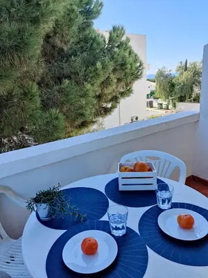 a table with plates of food on a balcony at Sunny Albufeira - 5min to the beach by LovelyStay in Albufeira