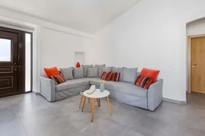 a living room with a couch and a table at Villa Petala in Albufeira