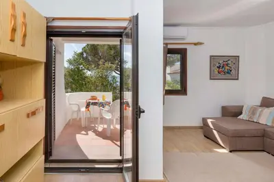 a living room with a sliding glass door leading to a patio at Apartment Maresia in Albufeira
