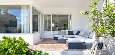 a living room with a couch and a patio at LongLands Peak at Windmill Hill in Albufeira