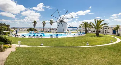 a windmill and a swimming pool with a windmill at LongLands Peak at Windmill Hill in Albufeira