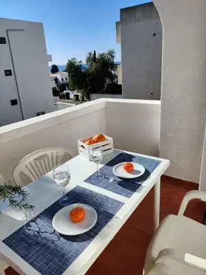 a table with two plates of oranges on a balcony at Bright Albufeira - 5min to the beach by LovelyStay in Albufeira