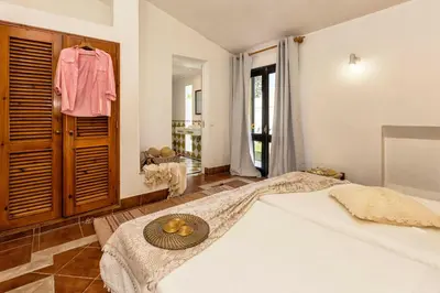 a bedroom with a large bed with a green wall at Villa Jacaranda in Albufeira