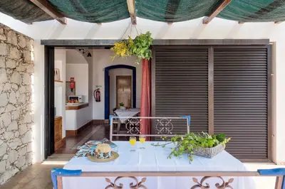 a bathroom with a tub and a sink and a mirror at Villa Jacaranda in Albufeira