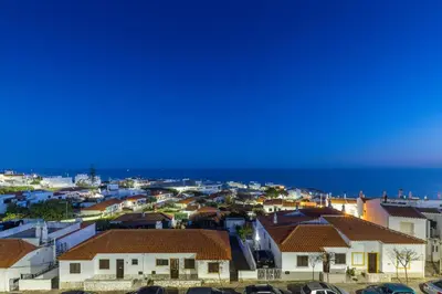 a view of a city with houses and the ocean at Oceanview Apartment A by Sequeira in Albufeira