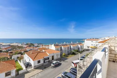 a view of a city street with buildings and the ocean at Oceanview Apartment A by Sequeira in Albufeira
