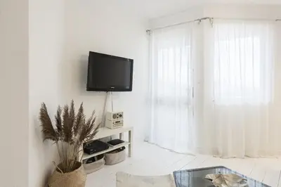 a living room with a flat screen tv on a wall at Scandic - City Center by HD Properties in Vilamoura