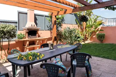 a patio with a table and chairs and a fireplace at Villa Anabela in Albufeira