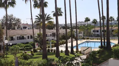a view of a resort with palm trees and a pool at Vila Alba by Albufeira Rental in Albufeira