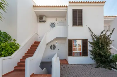 a white house with stairs leading up to it at Vila Alba by Albufeira Rental in Albufeira