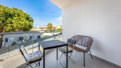 a table and two chairs on a balcony with a view at Dream Apartment W/Pool & Balcony by LovelyStay in Albufeira