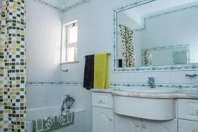 a bathroom with a sink and a mirror at Villa Malu in Albufeira