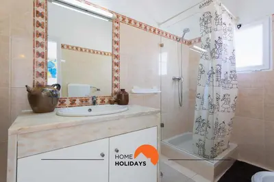 a bathroom with a sink and a shower with a shower curtain at #133 Vila Dias 1 by Home Holidays in Albufeira