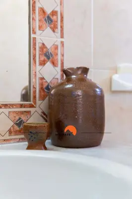 a brown vase sitting on a counter in a bathroom at #133 Vila Dias 1 by Home Holidays in Albufeira