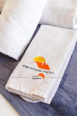 a pair of napkins with an umbrella sign on them at #114 T2 Foxy H by Home Holidays in Albufeira