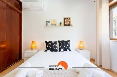 a bedroom with a bed and two night stands at #114 T2 Foxy H by Home Holidays in Albufeira