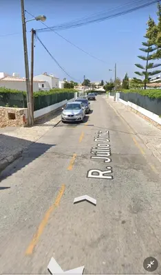 a street with cars parked on the side of the road at Candyland Apartment in Albufeira