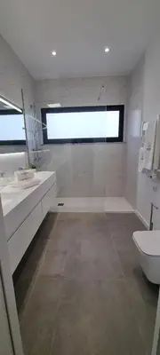 a white bathroom with a sink and a toilet at Valverde 2 Villa, Vilamoura, Algarve, only 5 minutes from Marina, Golf and Beach in Vilamoura