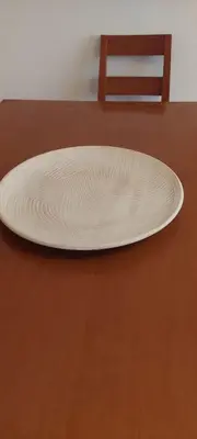 a plate sitting on top of a wooden table at Appart Oura Strip in Albufeira