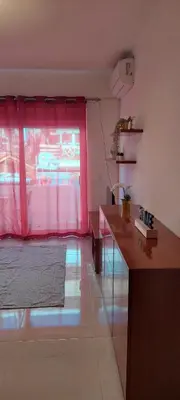 a living room with a red curtain and a window at Appart Oura Strip in Albufeira