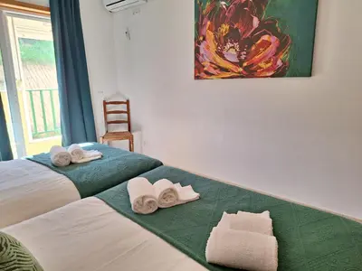 a bedroom with two beds with towels on them at Ondasol- acolhedor T2 na cidade velha in Albufeira