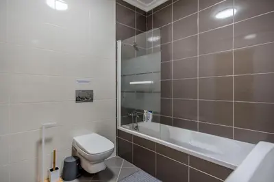 a bathroom with a toilet and a bath tub at Villa Casa Vilas Boas in Albufeira