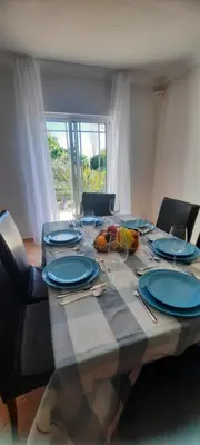 a dining room table with black chairs and a dresser at Villa Pretty Stunning House with Garden and Private Swimming Pool in Almancil