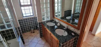 a bathroom with two sinks and a large mirror at Villa Pretty Stunning House with Garden and Private Swimming Pool in Almancil