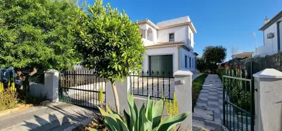 a white house with a tower on top of it at Villa Pretty Stunning House with Garden and Private Swimming Pool in Almancil