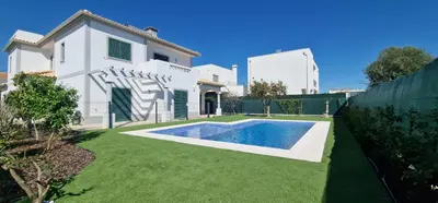a swimming pool in a yard next to a house at Villa Pretty Stunning House with Garden and Private Swimming Pool in Almancil