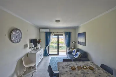 a living room with a table and a dining room at Vista das Ondas - Apartamento 204 in Albufeira