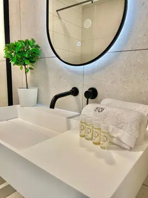 a bathroom sink with two bottles of soap on it at F&V Studio Vilamoura in Quarteira
