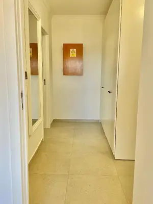 an empty hallway with a tile floor at F&V Studio Vilamoura in Quarteira