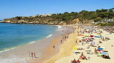 a group of people on a beach with the ocean at Perfect location for nightlife @ the Strip in Albufeira