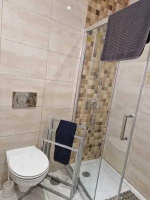a bathroom with a toilet and a glass shower at Perfect location for nightlife @ the Strip in Albufeira
