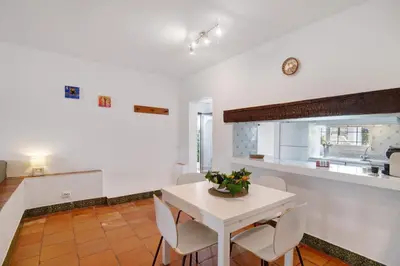 a kitchen and dining room with a white table and chairs at Apartment Mar Azul 1 in Albufeira