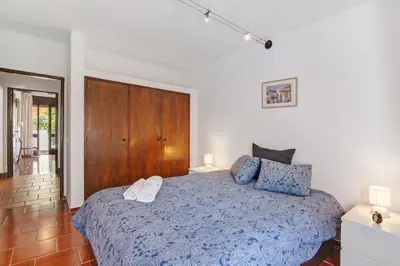 a bedroom with a blue bed with a wooden door at Apartment Mar Azul 1 in Albufeira