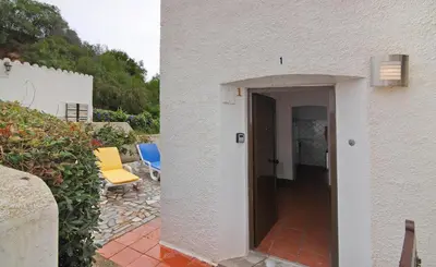 a hallway to a house with a door and chairs at Apartment Mar Azul 1 in Albufeira