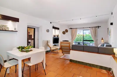 a living room with a table and a couch at Apartment Mar Azul 1 in Albufeira