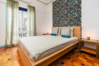 a bedroom with a bed and a large window at Happen!ng 2 in Faro