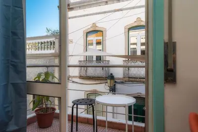 a view from a window with a table and two stools at Happen!ng 2 in Faro