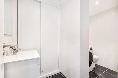 a white bathroom with a toilet and a sink at Ria Mar Deluxe - City Center @Homesbyfc in Faro