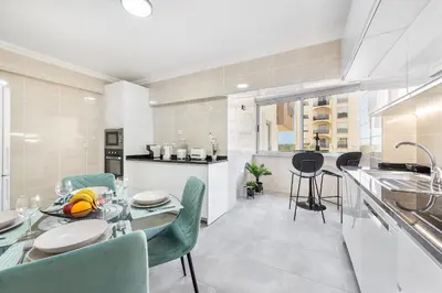 a kitchen and dining room with a table and chairs at Ria Mar Deluxe - City Center @Homesbyfc in Faro