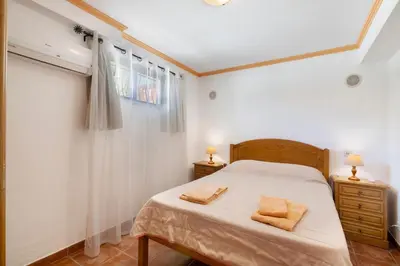 a bathroom with a toilet and a sink and a shower at Villa Trindade in Albufeira