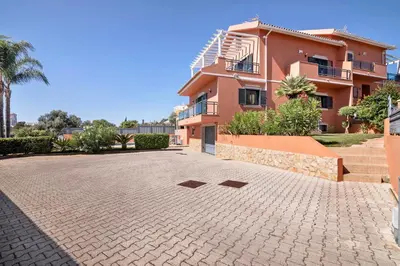 a large house with a brick driveway in front of it at Villa Trindade in Albufeira