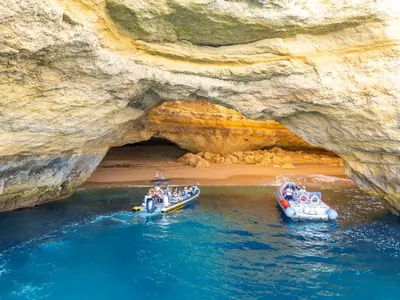 two boats in the water in front of a cave at Villa Isis by Algarve Vacation in Albufeira