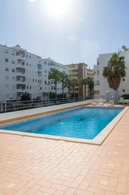 a swimming pool in the middle of a building at Ocean Blue in Quarteira