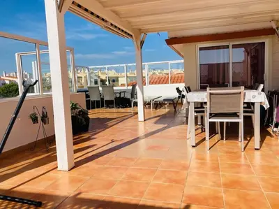 a patio with a table and chairs on a balcony at Penthouse T2 pool Terrace time in Albufeira