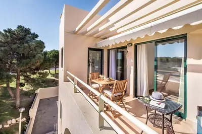 a balcony of a house with a table and chairs at Casa dos Salgados in Guia