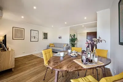 a living room with a wooden table and yellow chairs at Casa dos Salgados in Guia